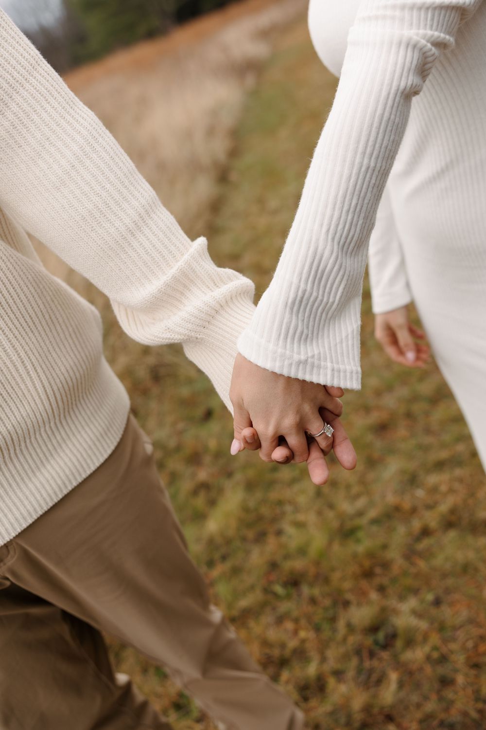 Close-up series showing hands in white sweater sleeves against brown pants and grass background.