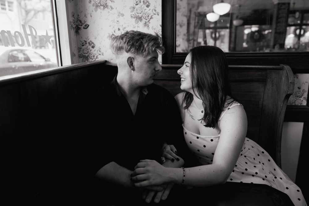 A romantic couple sharing intimate moments in a dimly lit setting.