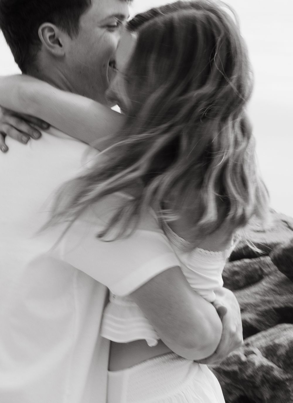 Black and white intimate portrait of a couple in soft focus.
