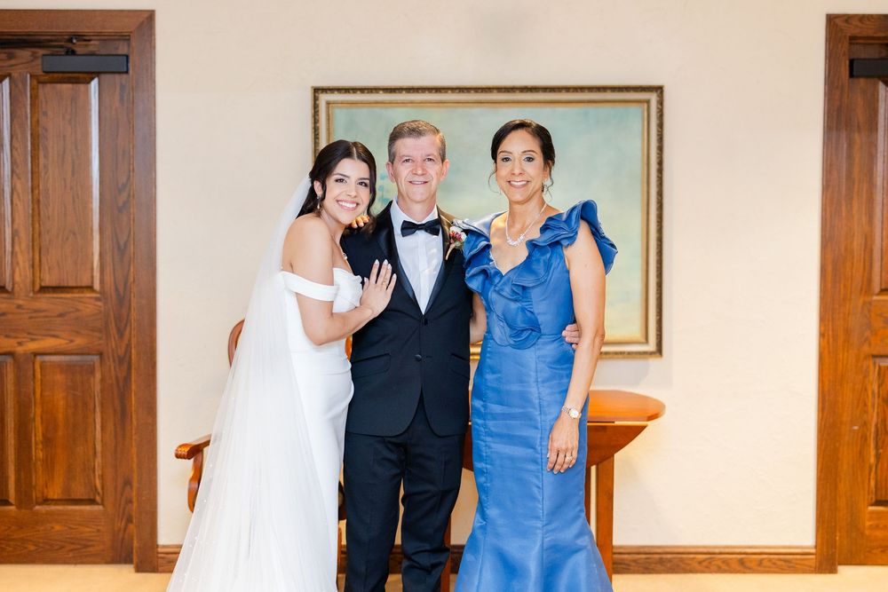 A joyful wedding celebration in a warm interior space with wooden accents.