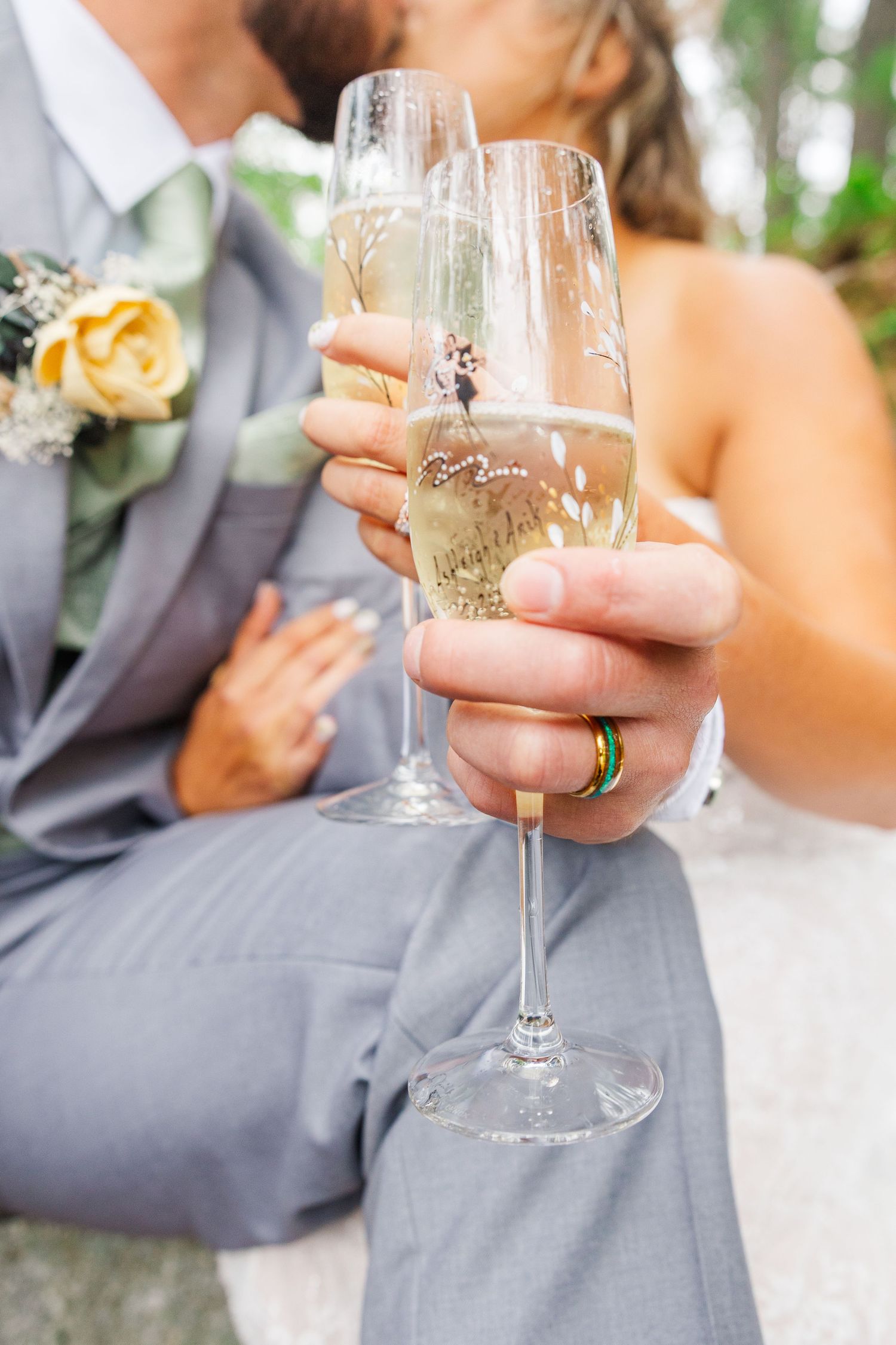A tender moment between newlyweds outdoors with trees and nature in the background on their wedding day.