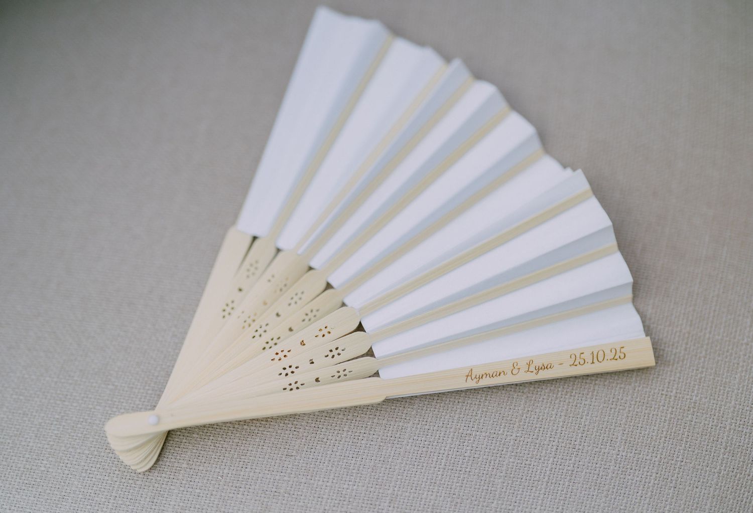 White paper fan showing progressive stages of unfolding against a neutral gray background.