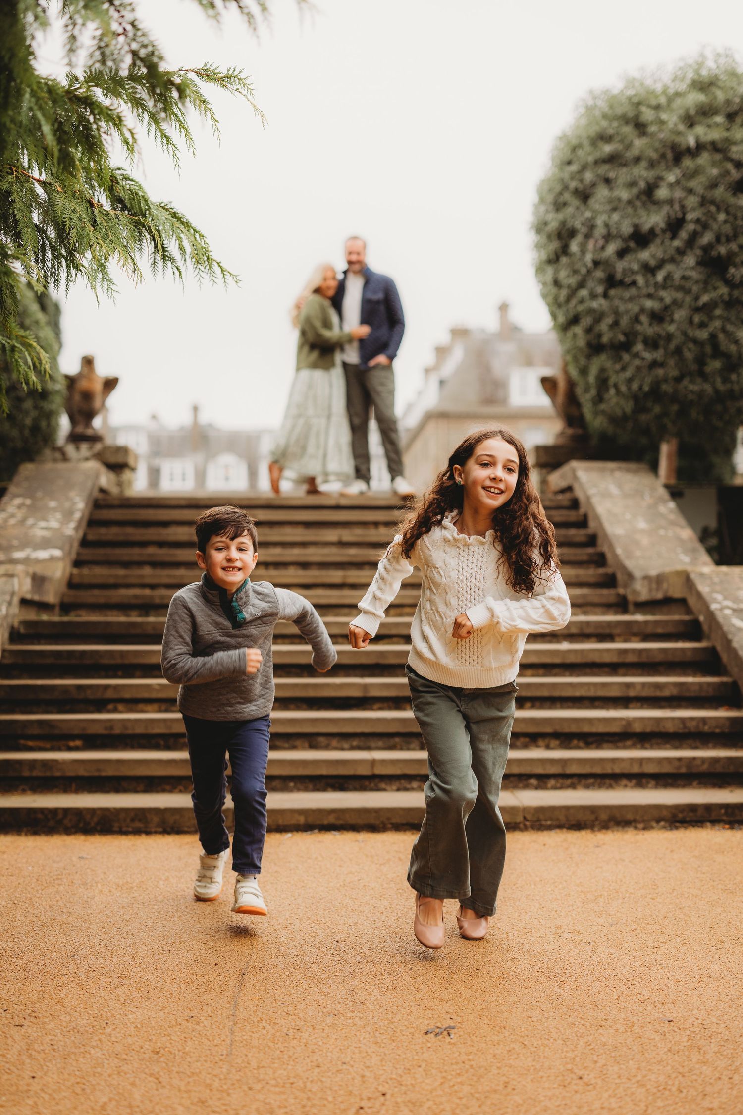 A sequence of playful moments captured on outdoor stone steps in a garden setting.