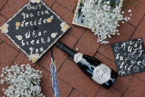 Decorative chalk messages and drawings scattered on red brick pavement.