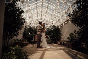 Elegant glass conservatory with white beams and natural lighting creates a stunning wedding venue interior.