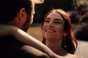 Candid wedding moment captured during golden hour with soft lighting.