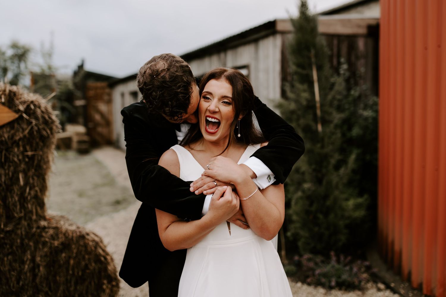 A collection of candid wedding photos showing joyful moments between a couple in a rustic outdoor setting.