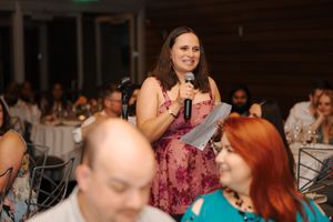 A group of people enjoying a celebration or event in a banquet hall setting.