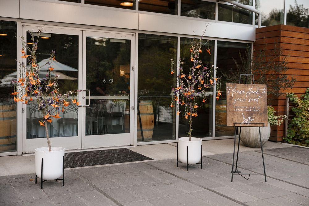 Modern storefront exterior with large windows and brick accents at a wedding venue location.