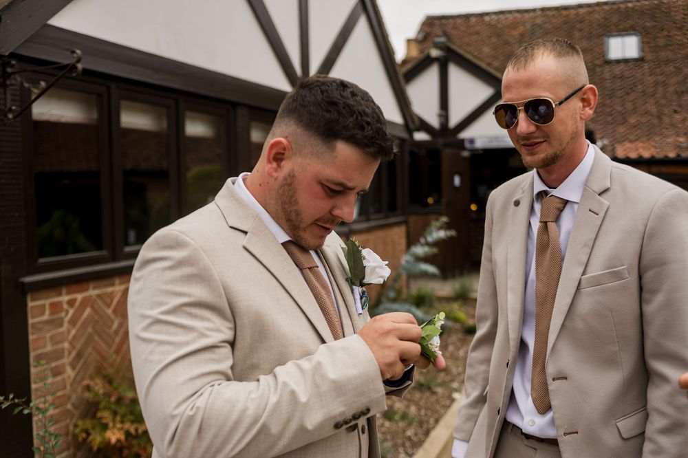 Wedding party members share drinks and laughs during reception celebration.