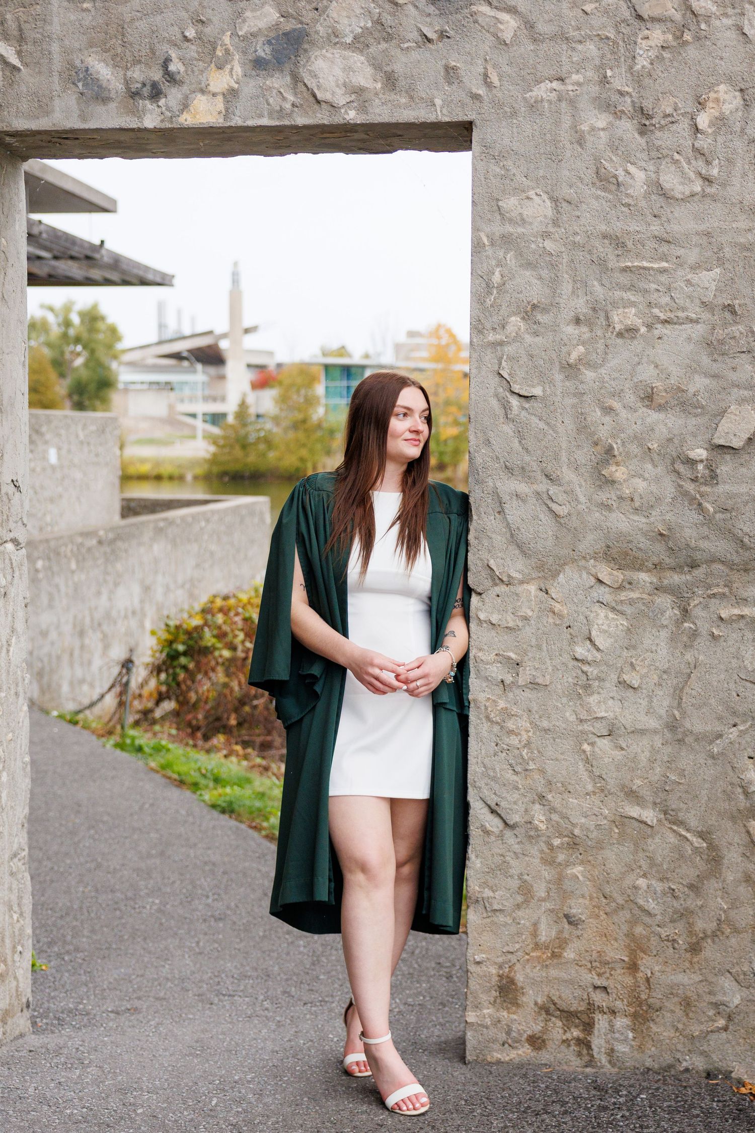 A series of fashion portraits showing a green cardigan and white dress against a stone wall backdrop.
