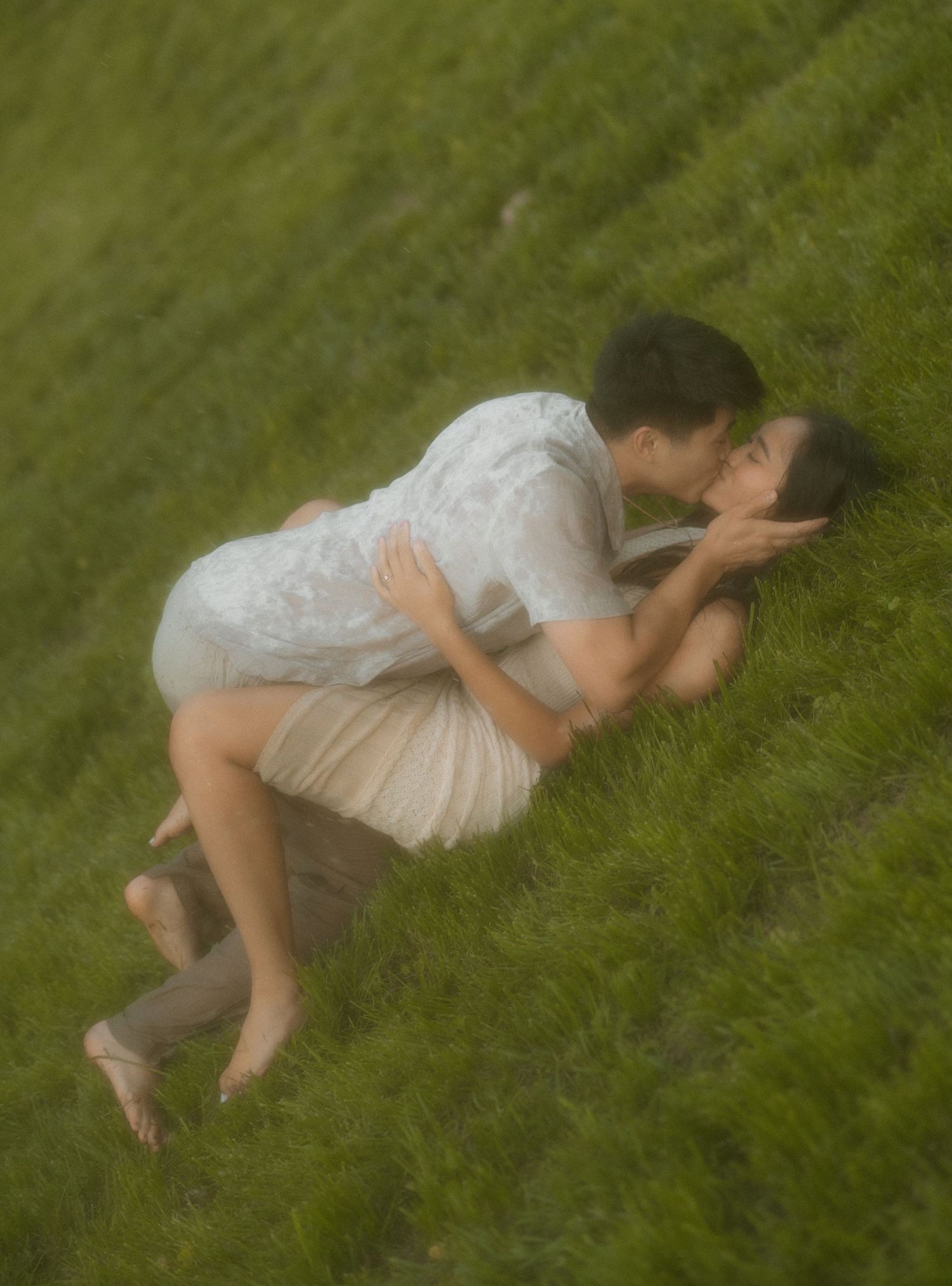 Intimate moment captured in golden field during sunset.
