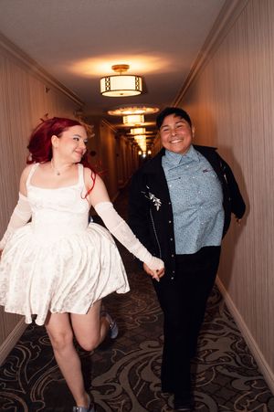Brides LGBTQ running down hallway at Las Vegas hotel after ceremony