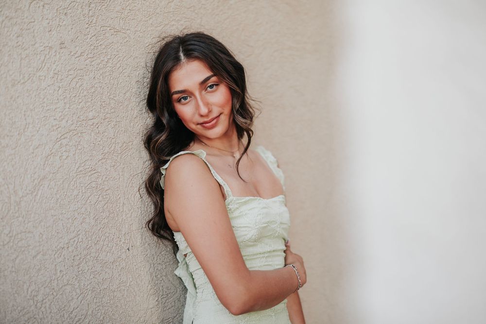 Indoor portrait series featuring a pale mint dress against a minimalist white wall backdrop.