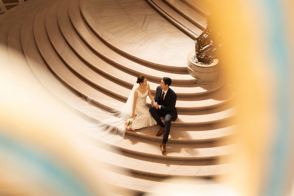 A sequence of minimalist architectural spiral staircases shown in warm lighting from different angles.