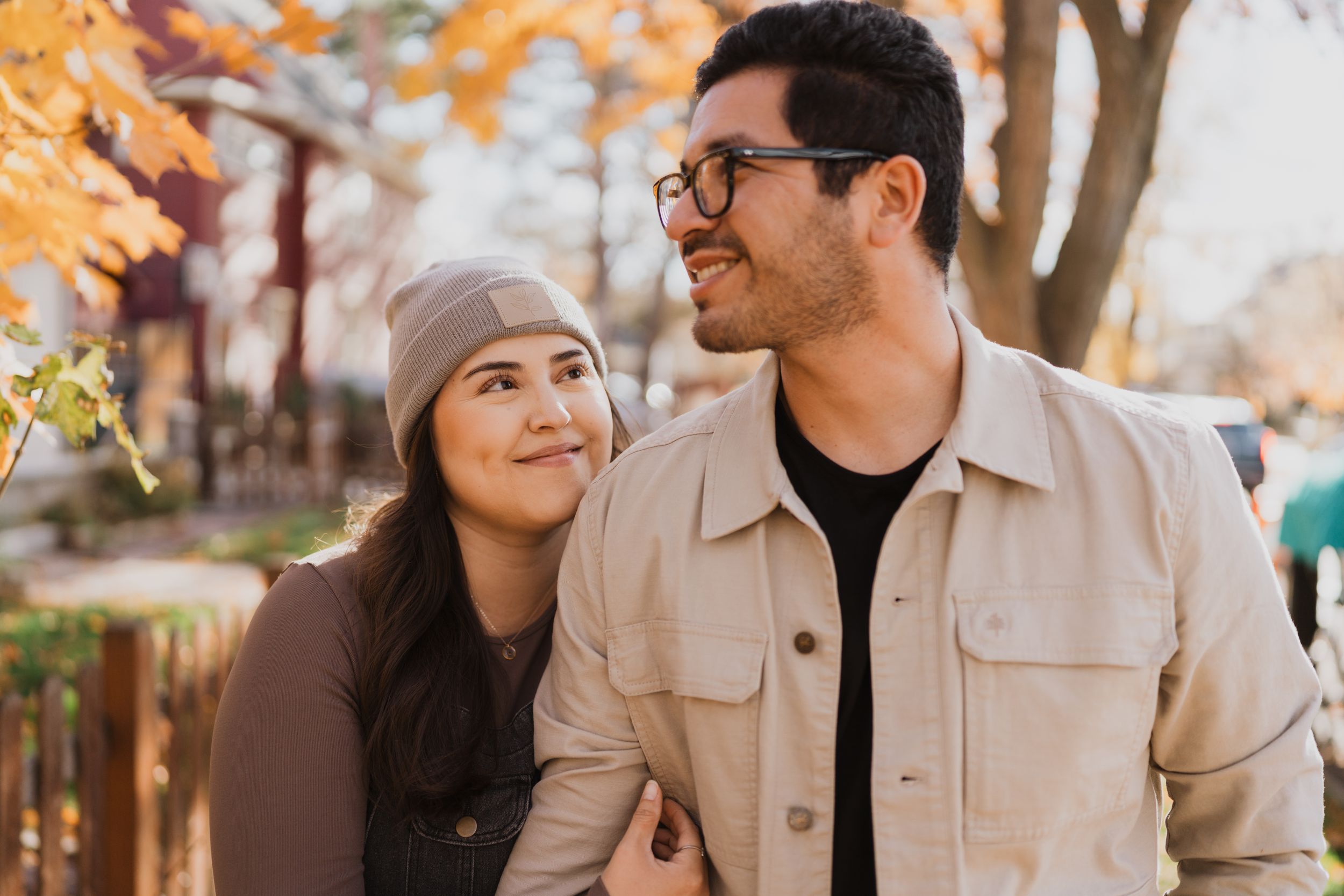 A couple shares joyful moments together during a sunset photoshoot in autumn.
