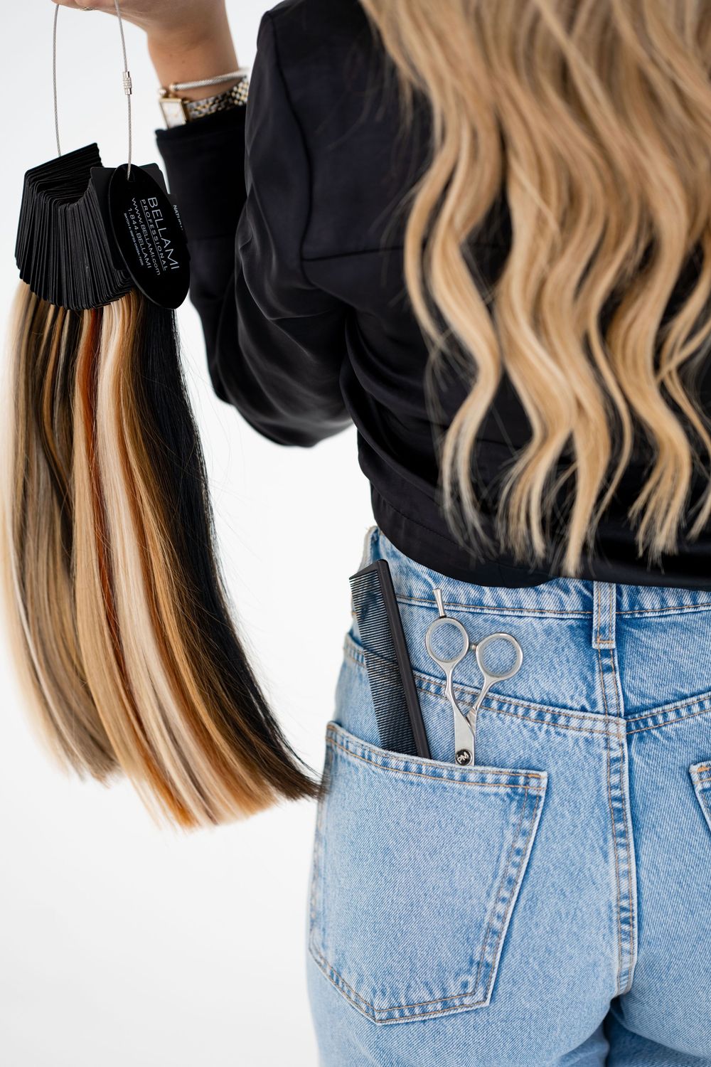 Close-up of hair extensions and denim jeans from behind.