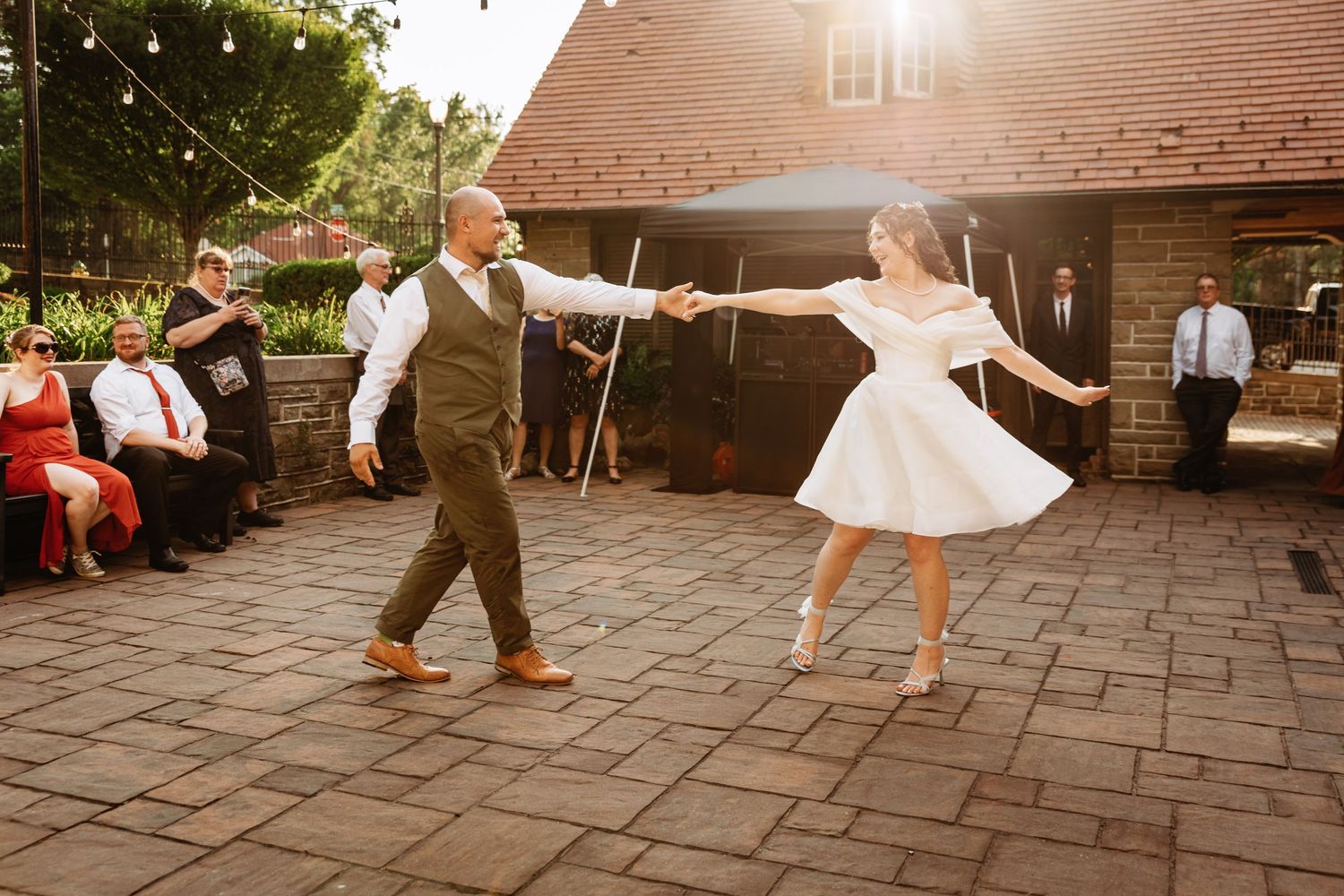 Bride and groom sharing a coordinated first dance on the patio at Highgate Carriage House | west virginia wedding photographer | fairmont wv