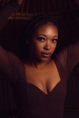 Artistic portrait series in moody lighting features dramatic shadows and dark tones.