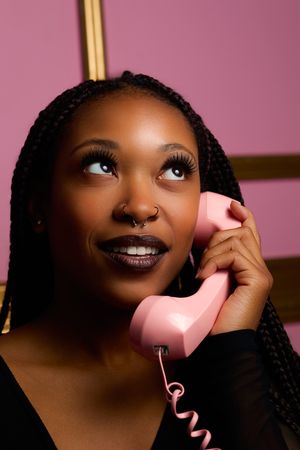 Beauty portrait series with pink backdrop showcasing glamorous makeup and dramatic lighting.