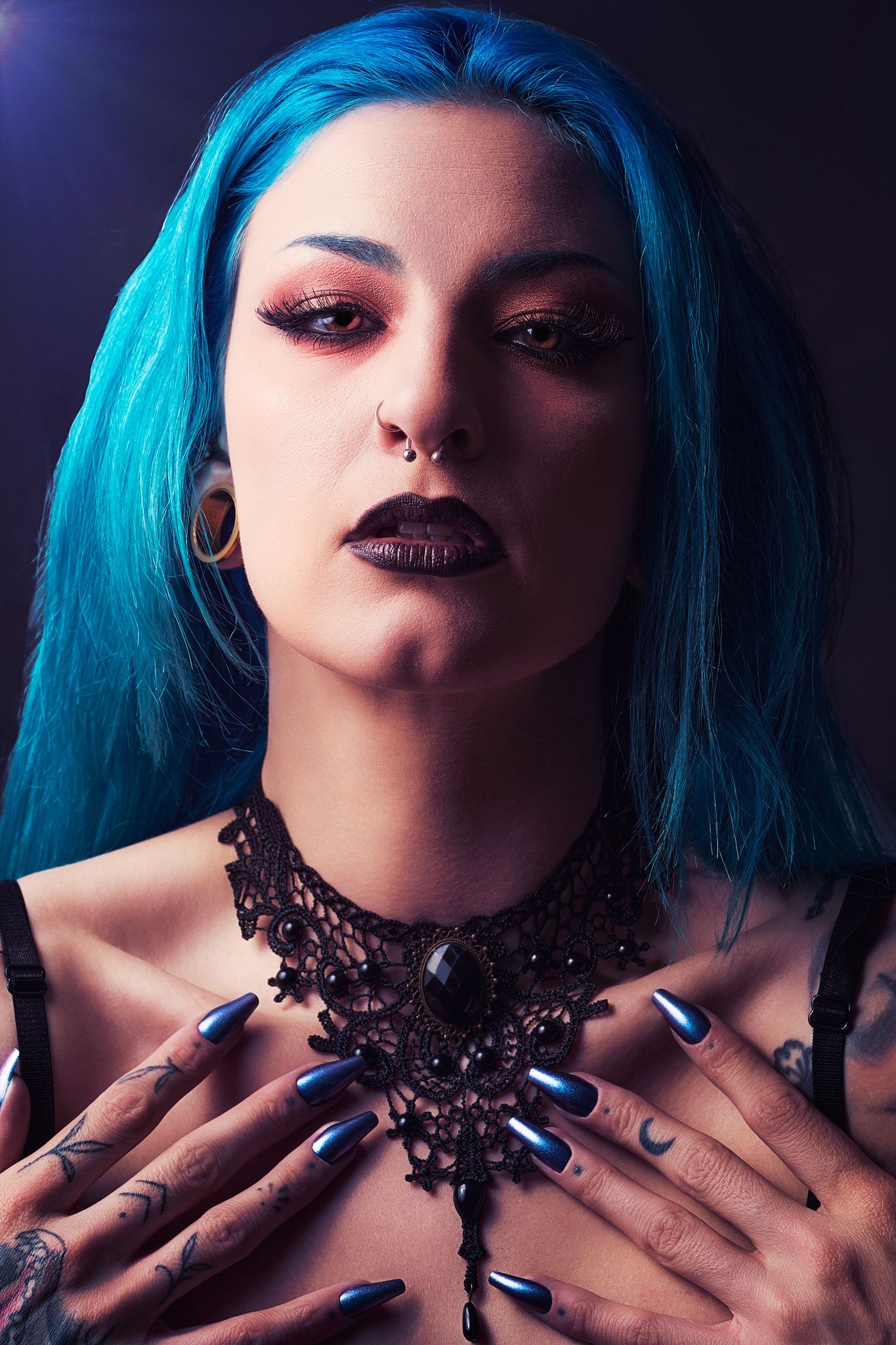 Gothic style portrait series with bright blue hair, dark makeup, and ornate black lace choker against dark background.