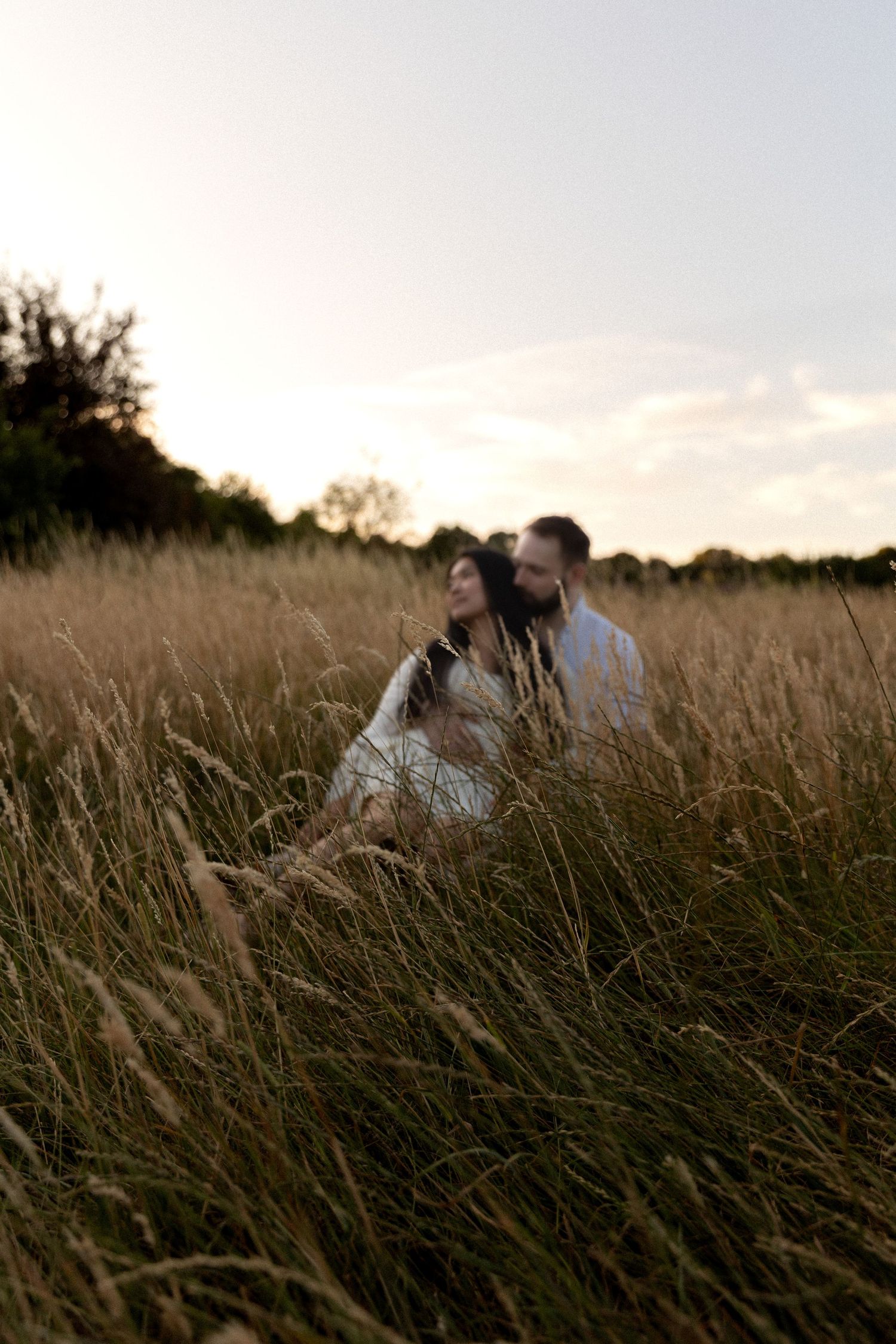 photograph of a couple in a golden field.