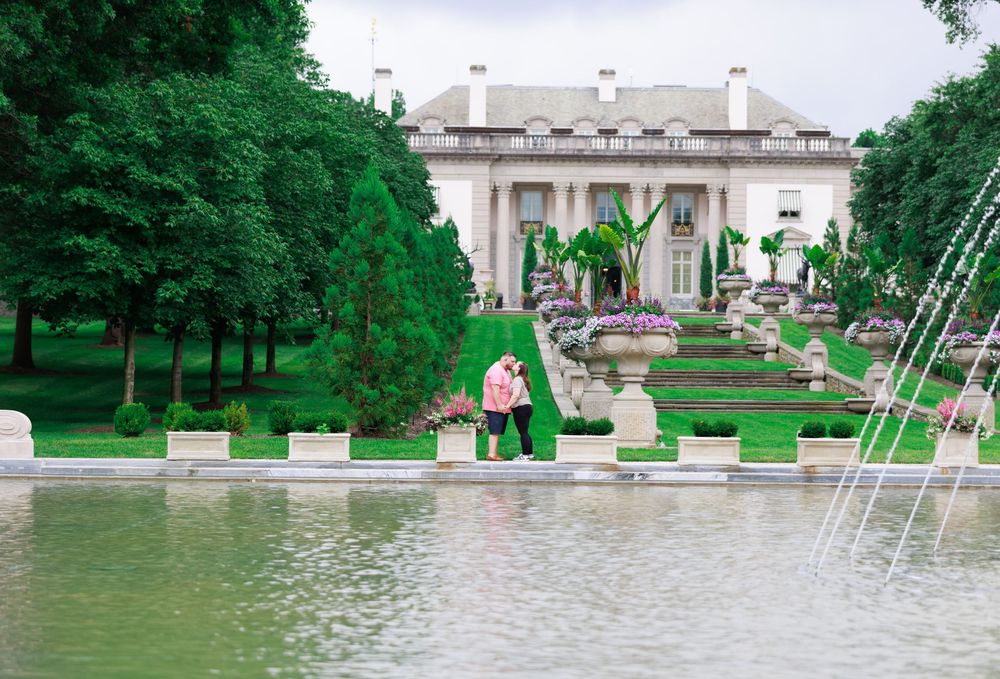 A panoramic view of a park with fountains and classical architecture.
