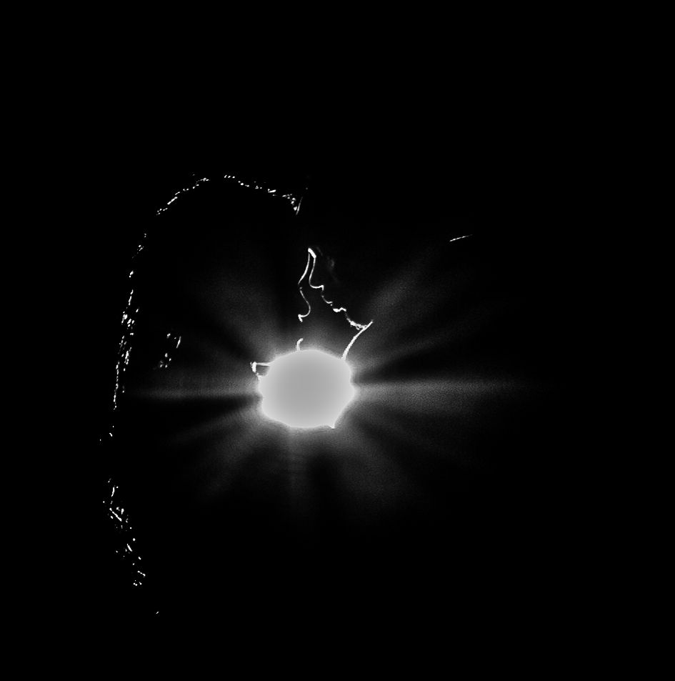 Black and white starburst effect showing bright light source with radiating beams.