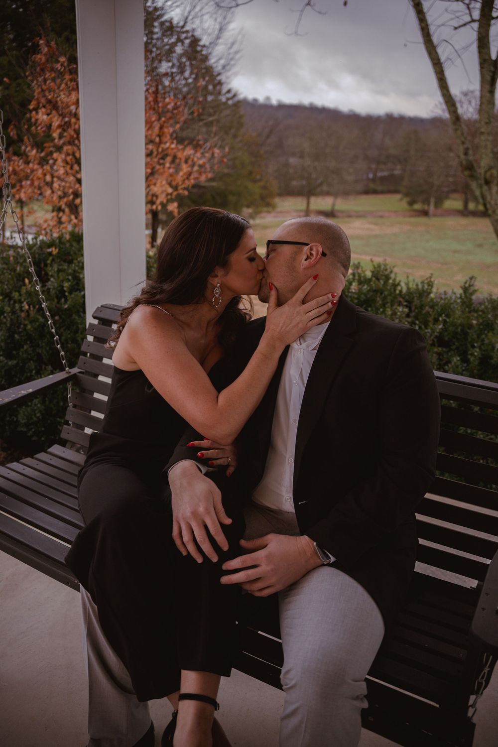 A tender moment shared on a wooden bench during autumn.