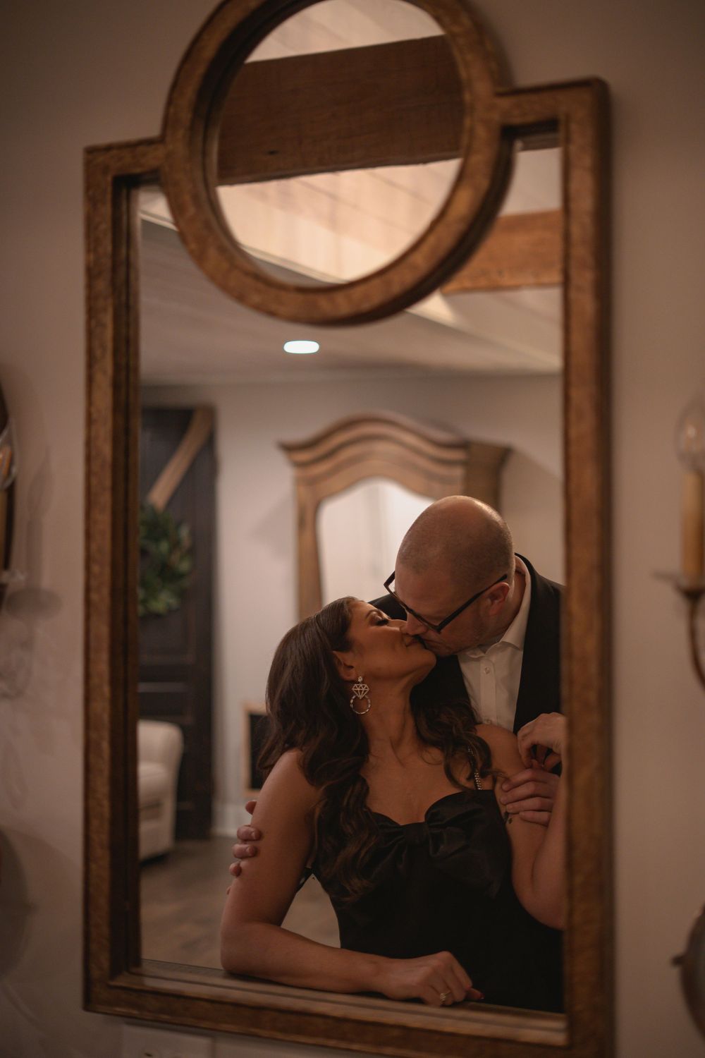 An intimate moment reflected in vintage-style mirrors with warm lighting.