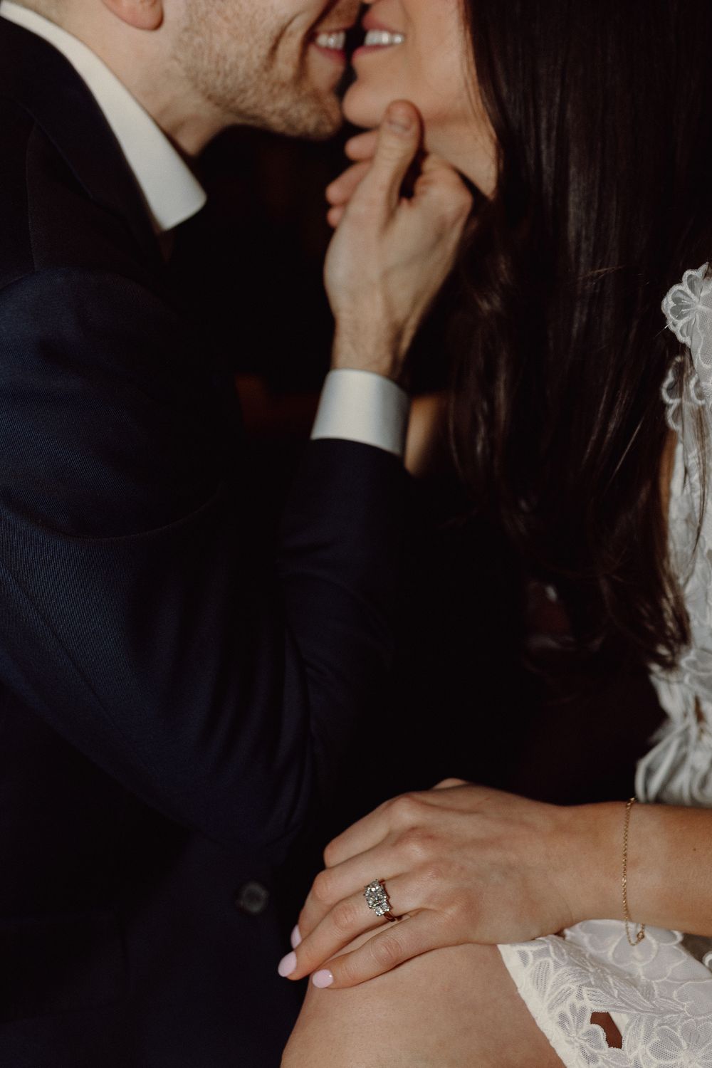 Close-up of tender moments between a couple, featuring an engagement ring.