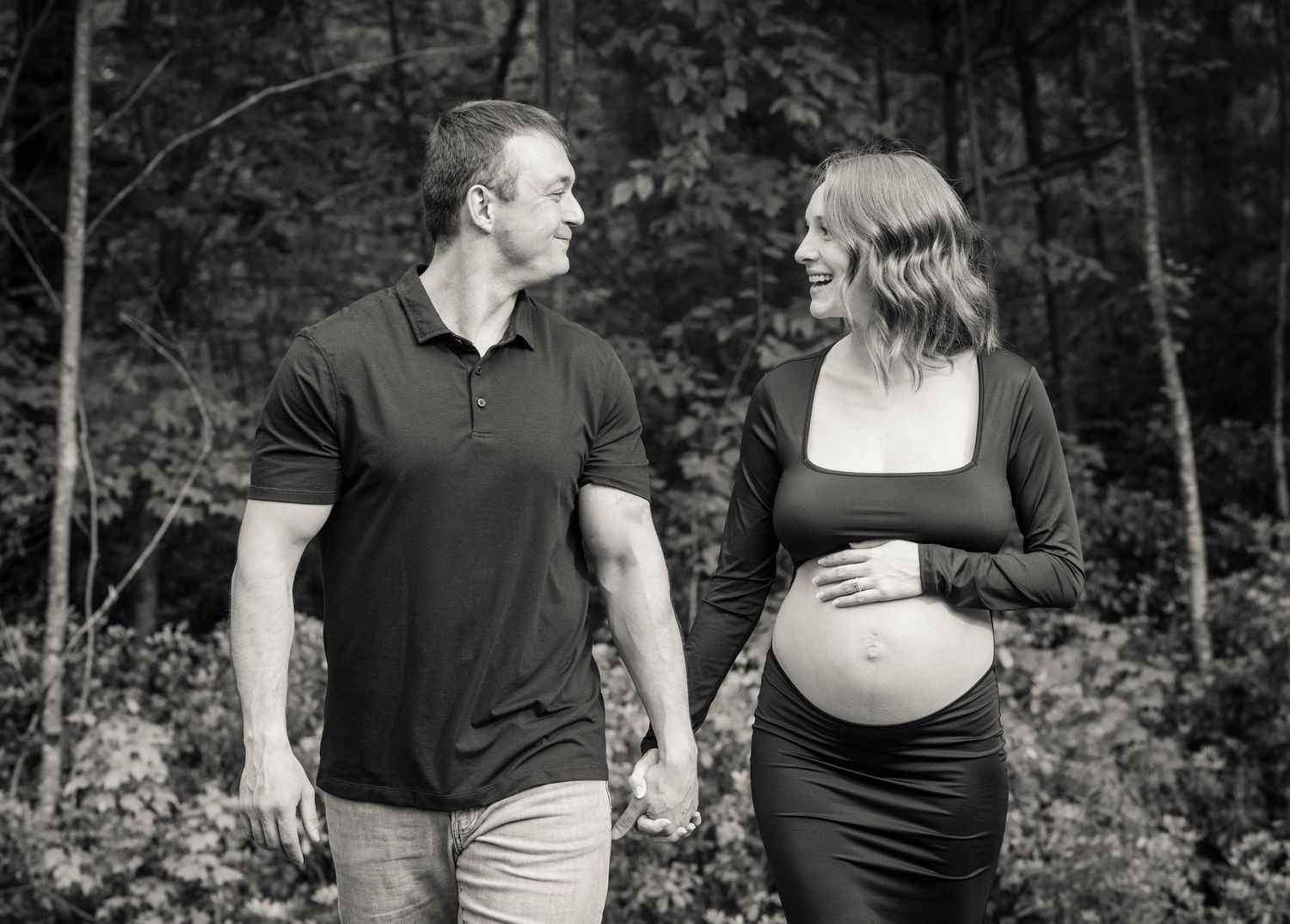 A series of black and white romantic couple photos showing intimate moments in a wooded outdoor setting.