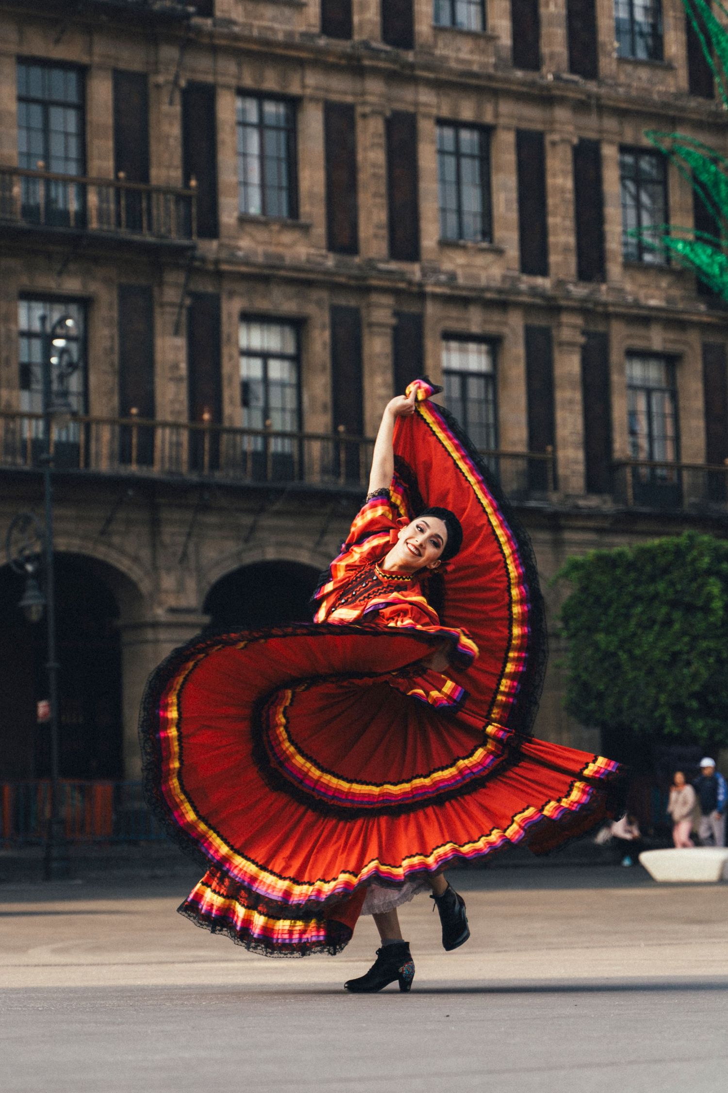 Ballet Folklórico dancer spinning traditional skirt in historic streets near Mexico City Metropolitan Cathedral