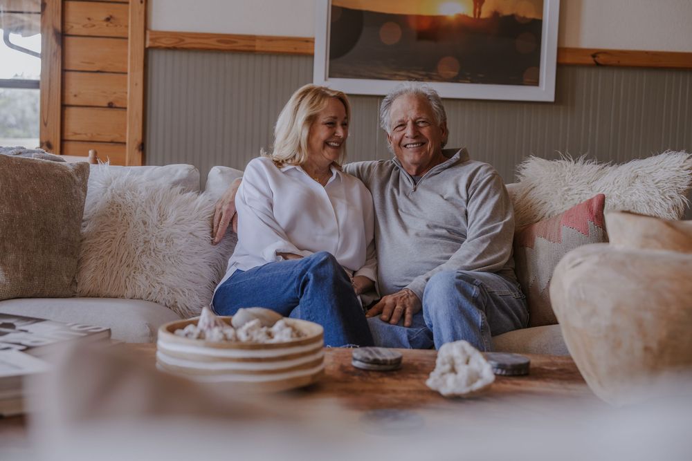 Cozy living room scene with people relaxing on sofa in cabin interior.