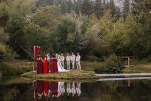 A scenic mountain lake surrounded by autumn trees with formal attire hanging on a clothesline.