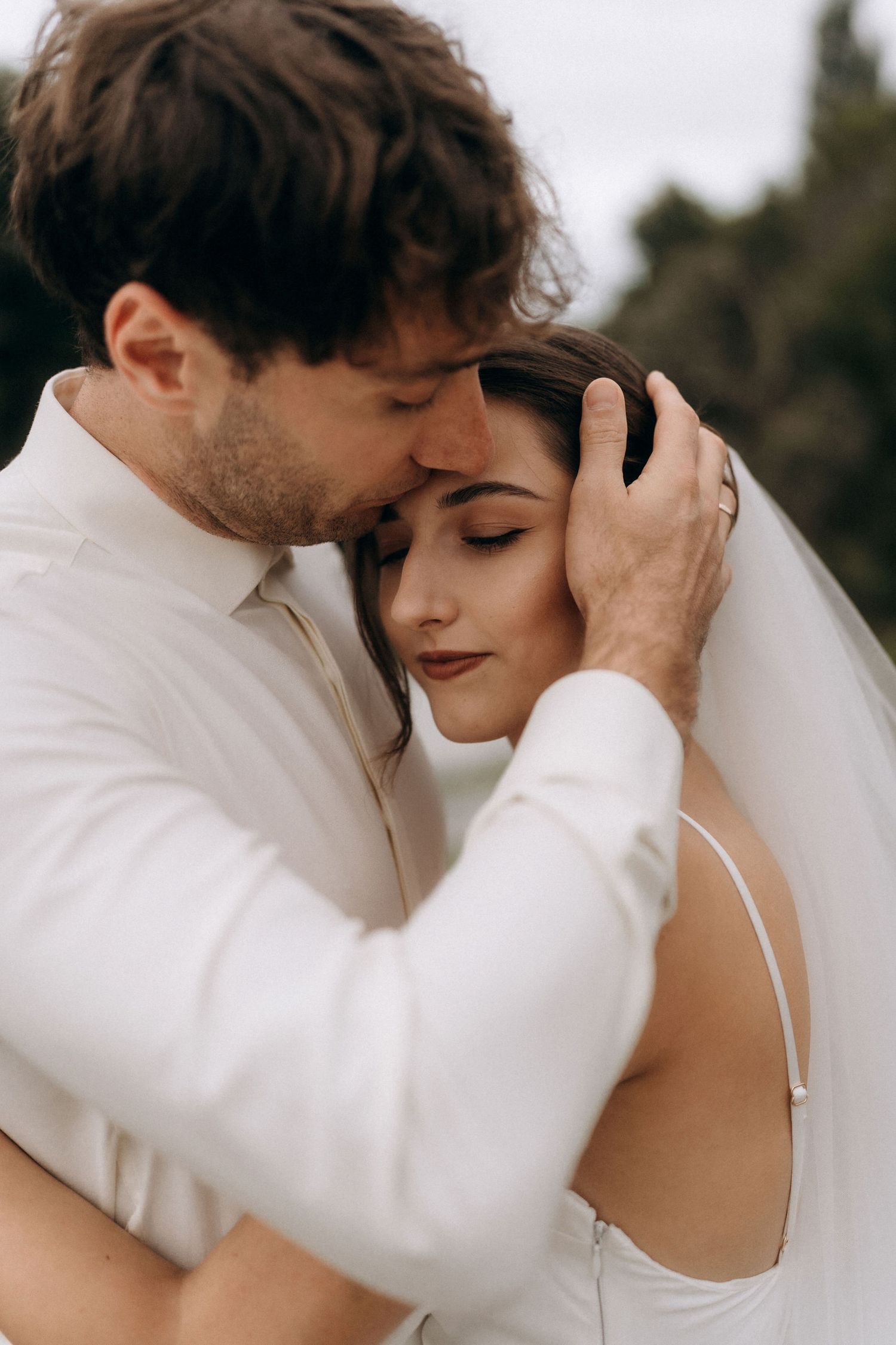 Intimate close-up wedding portrait showing tender moments between newlyweds.