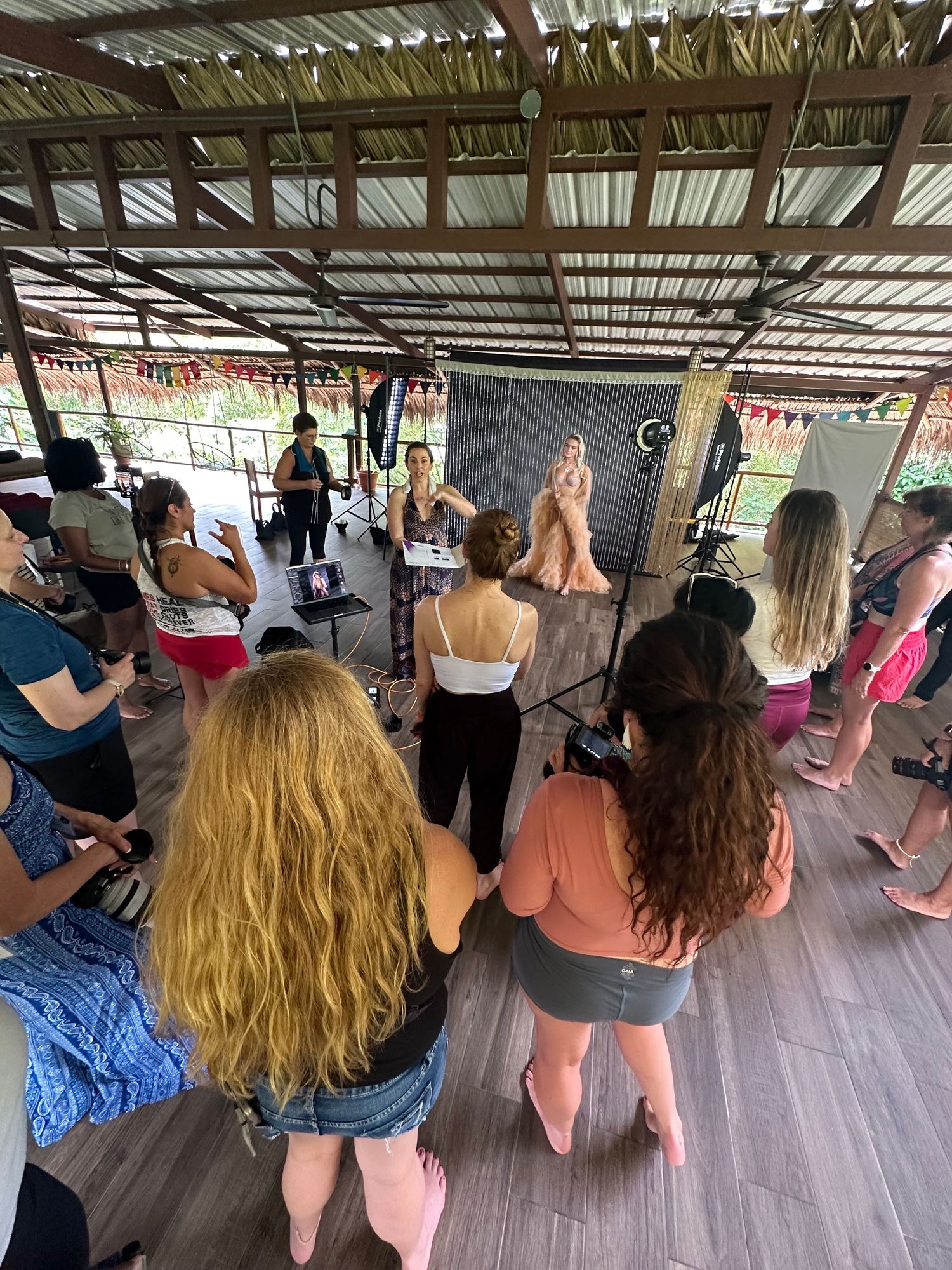 A group of people gathered under a covered outdoor space for what appears to be a dance or exercise class.