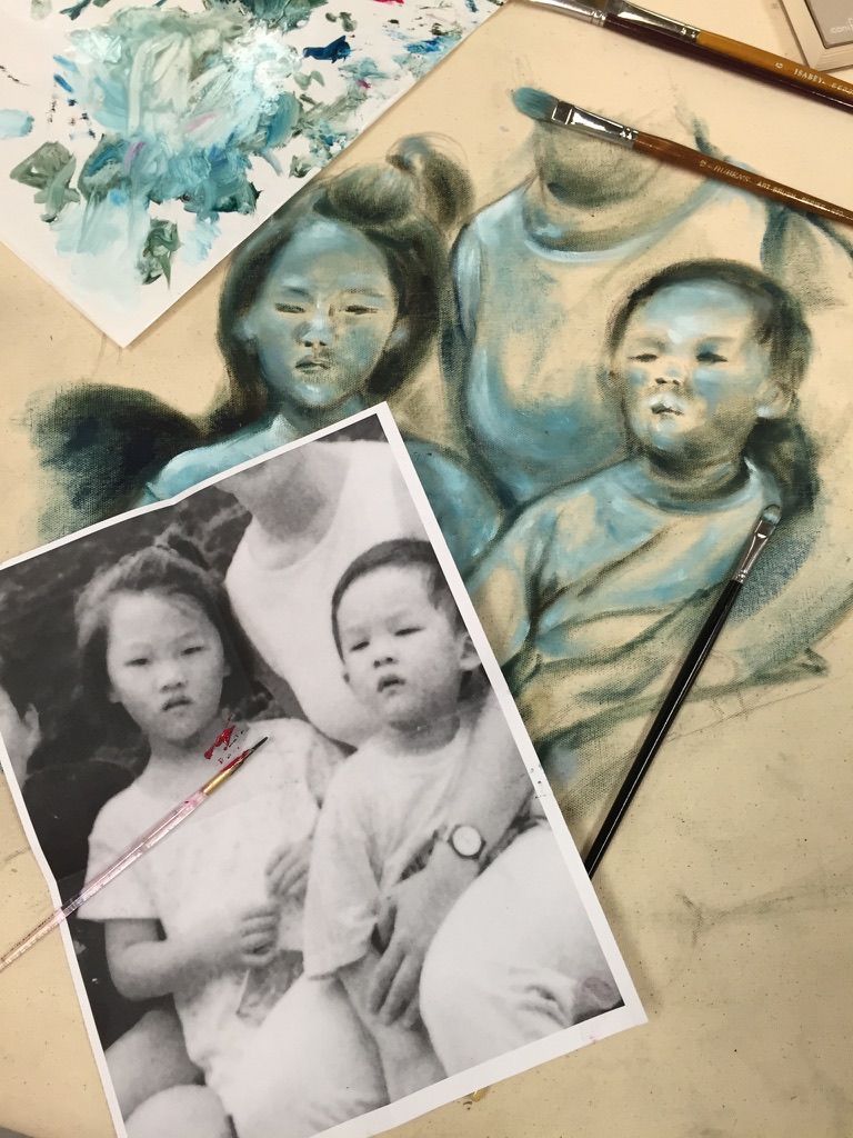 An artistic process showing the transformation of a black and white photograph into a watercolor painting on paper.