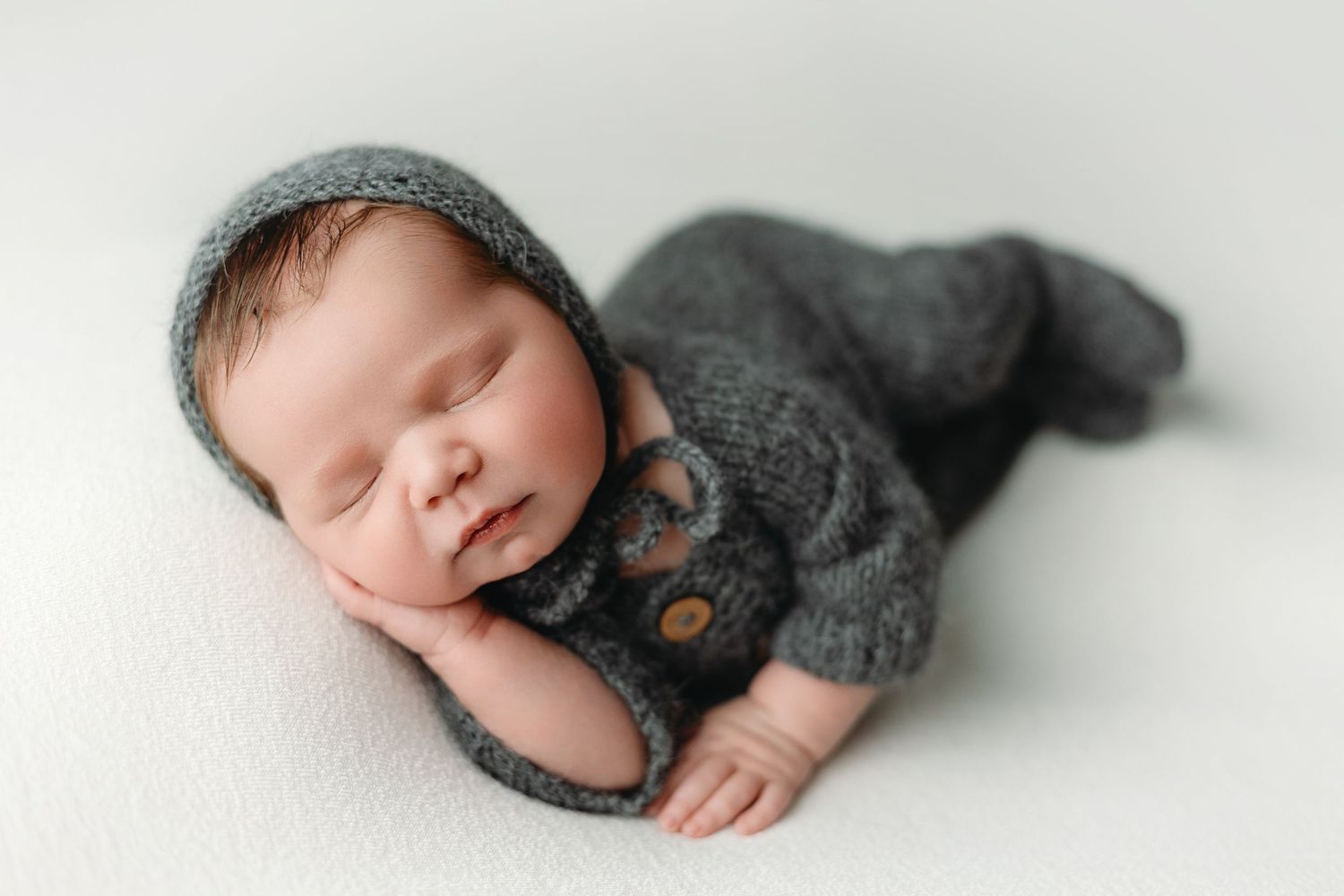 Newborn boy wearing an outfit in a side-lying pose. Greenville SC newborn photographer, Easley, SC newborn photographer, Upstate newborn