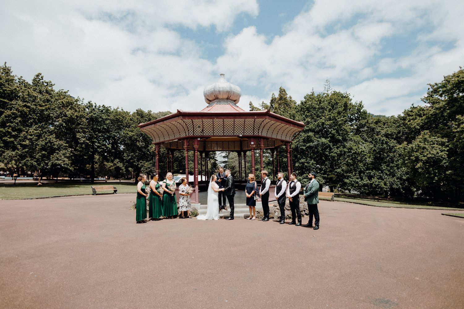 Wedding Ceremony under a gazebo in a park, captured by Apertured Media Auckland Wedding Photographer.