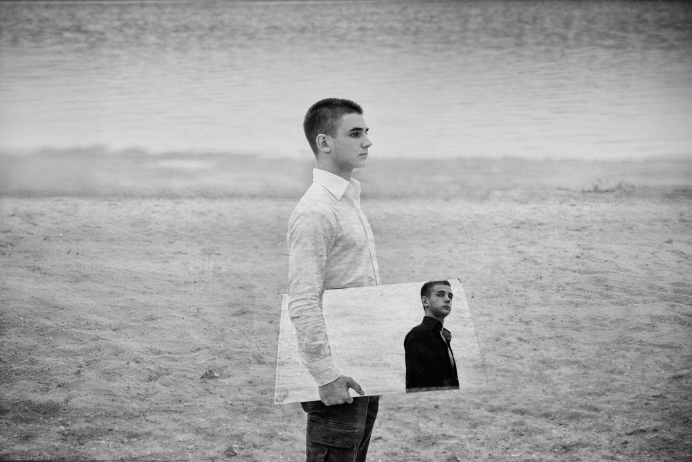 Double exposure black and white conceptual portrait exploring identity and space