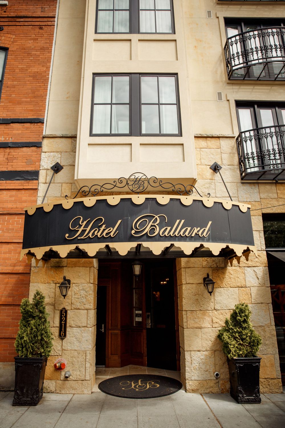 Elegant facade of Hotel Bullard with gold lettering and classic architectural details.