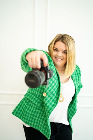 Dynamic shots showing green patterned jacket while holding camera equipment.