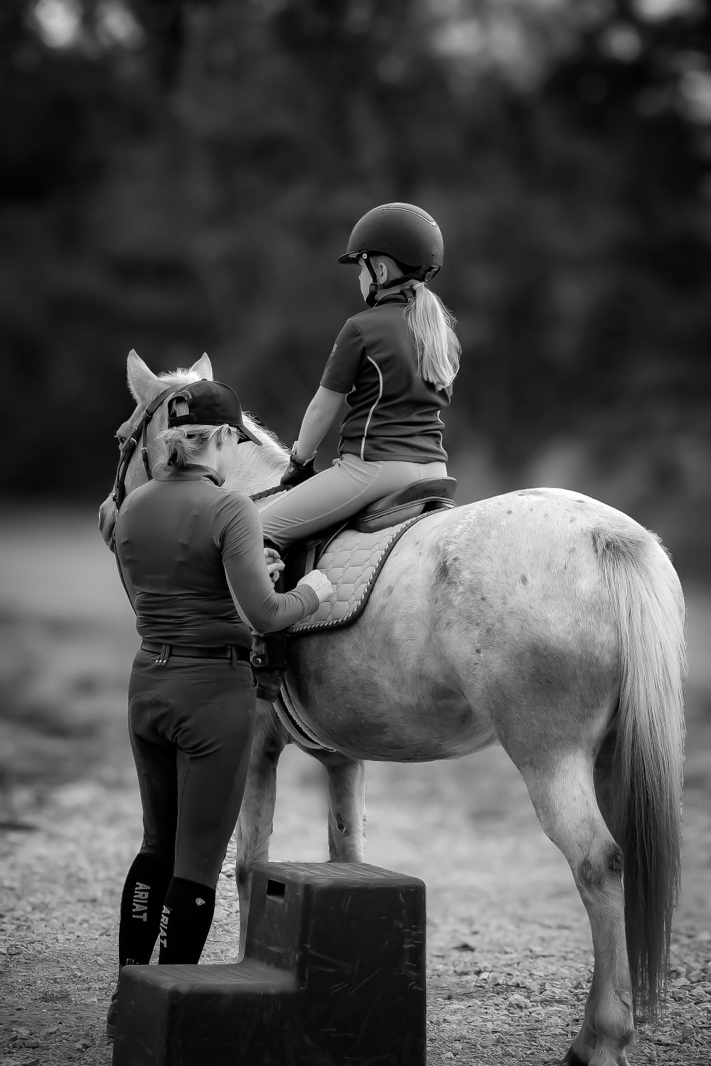 Little girl on her pony with her mother. English dressage clinic. English horse jumping. Horse and rider in Dripping Springs, Texas.