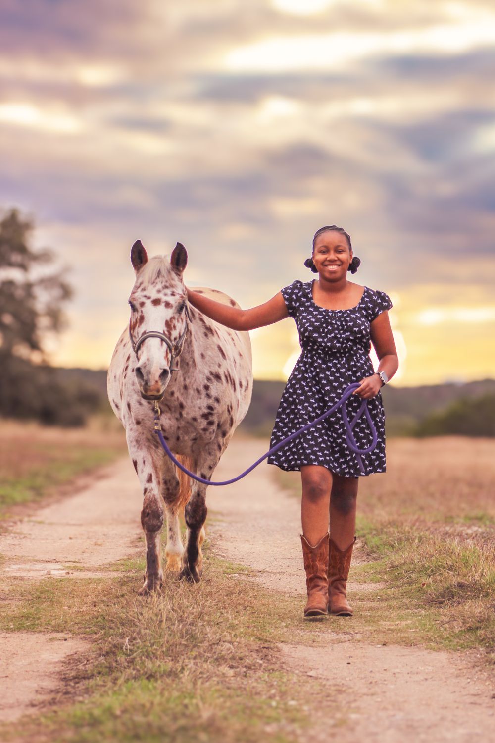 Teen with a dappled horse in Driftwood, Texas. Western boots. Pony and girl. Horse love. Equestrian bond. Sunset photo shoot.