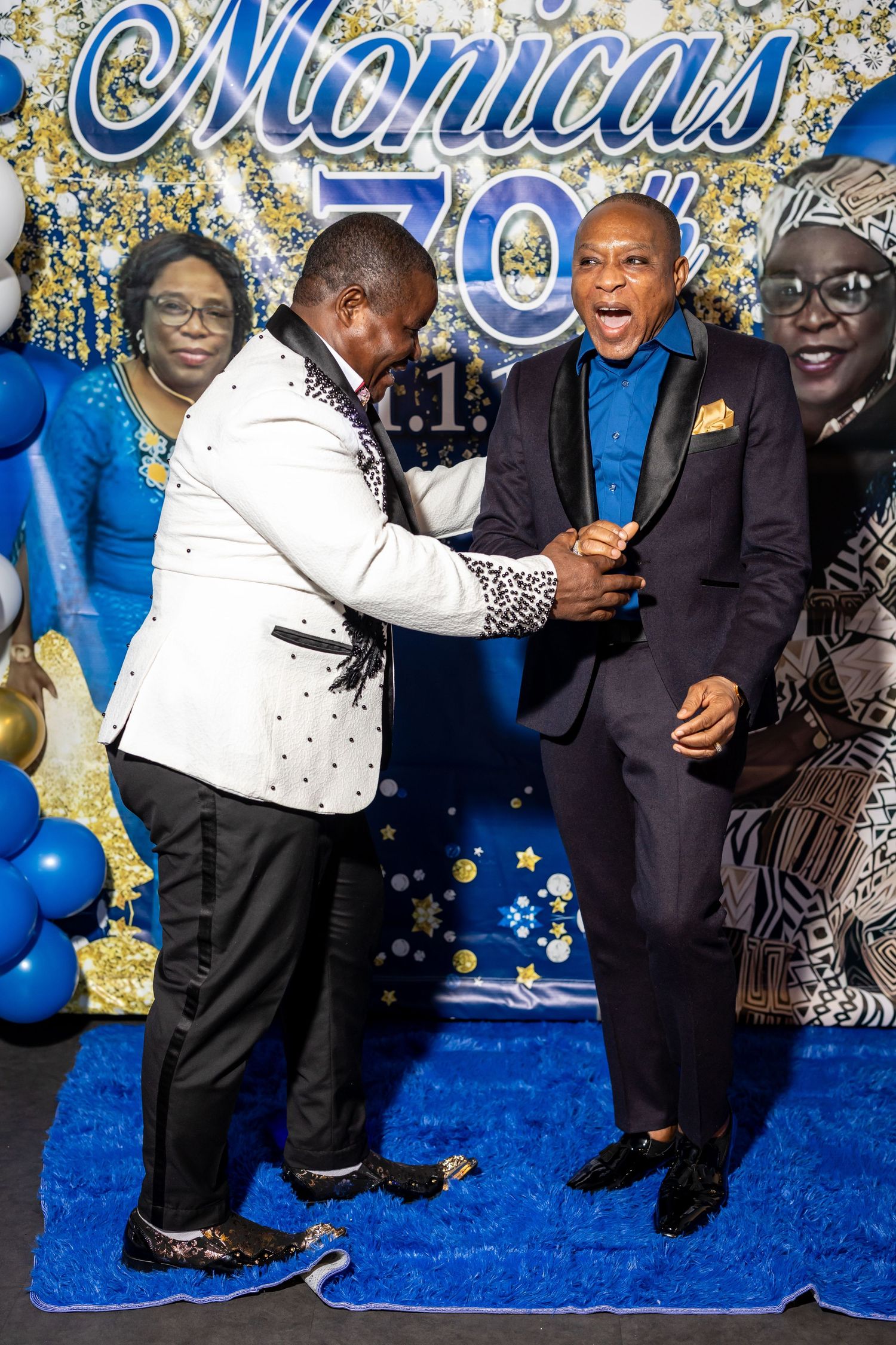A celebratory moment at a formal event with blue and gold decorations.