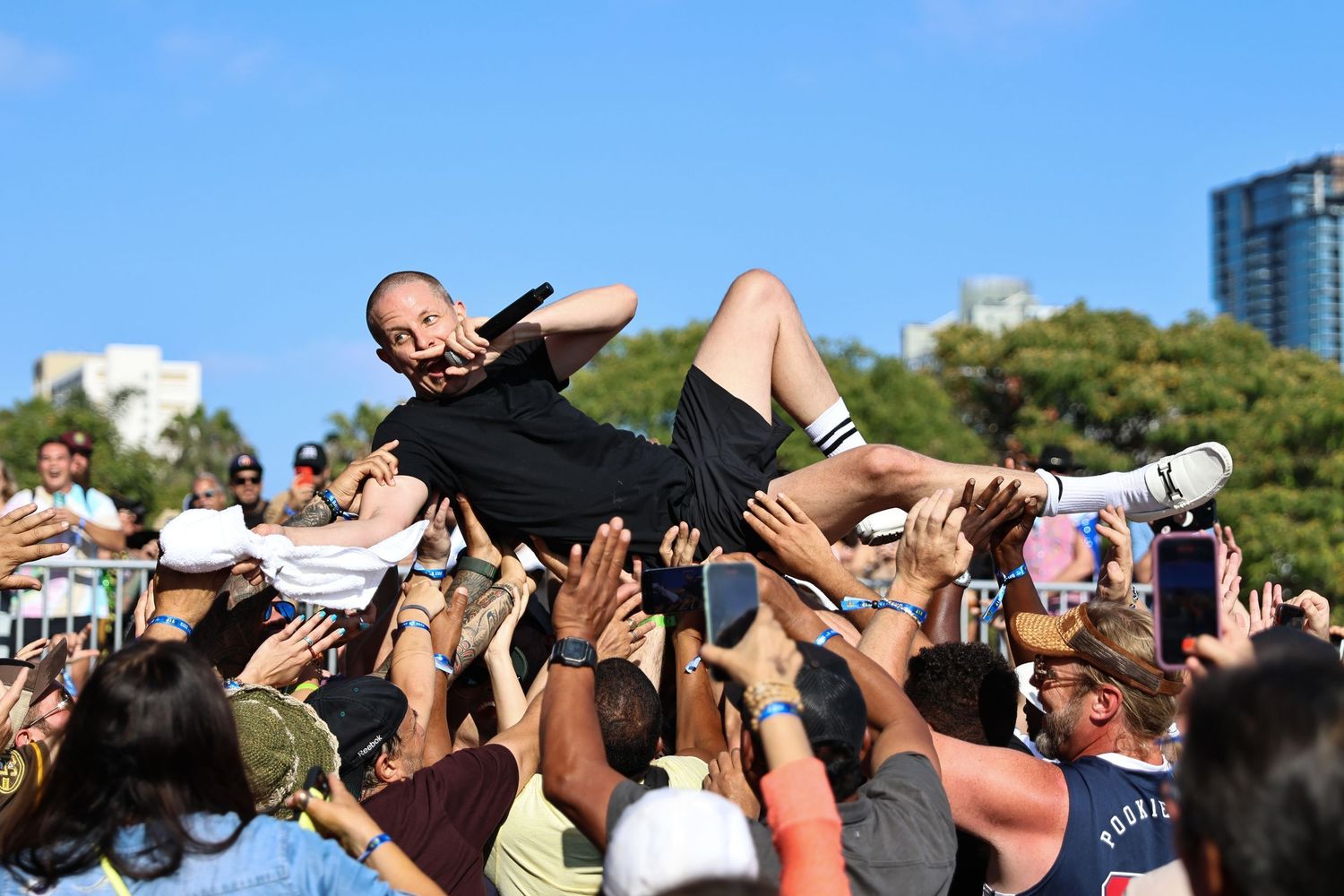 San Diego live music photography of rapper Prof crowd surfing while singing during his performance at Bayfest.