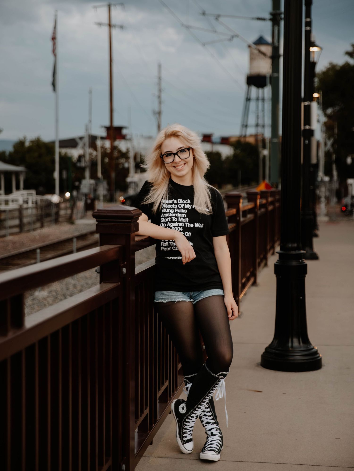 Girl poses, stands, and leans for senior photos, cinematic photos, and portraits in Arvada, Colorado outside and in nature photo