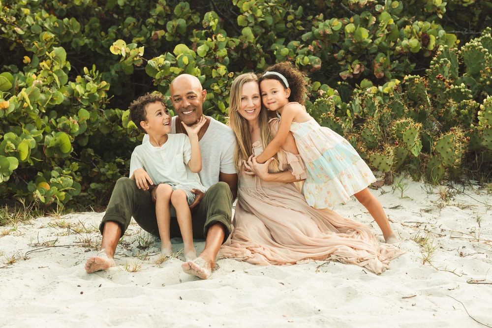 Family sitting in sand at the beach