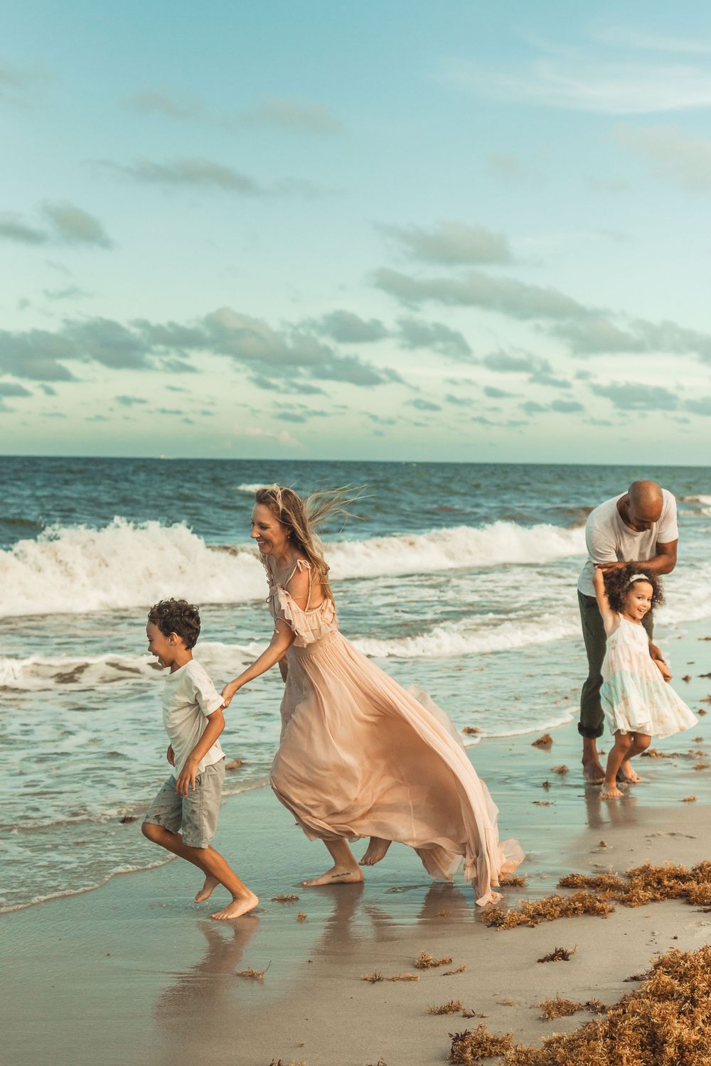 wild waves and wind in mom's dress. epic family photos